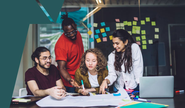 A group of people around a desk studying